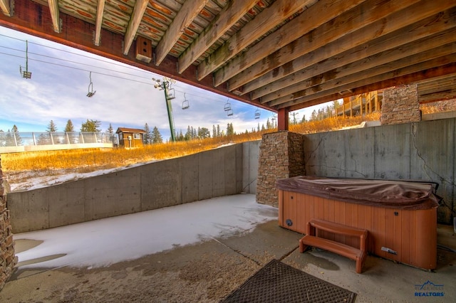 view of patio / terrace with a hot tub