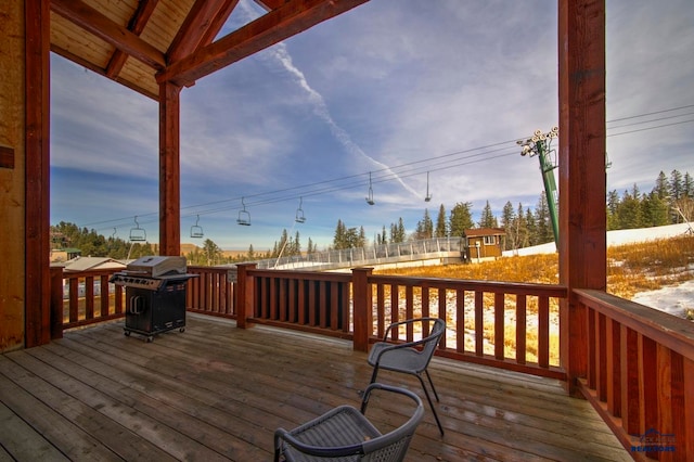 wooden terrace featuring grilling area