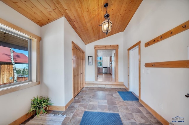 hall featuring wooden ceiling and vaulted ceiling