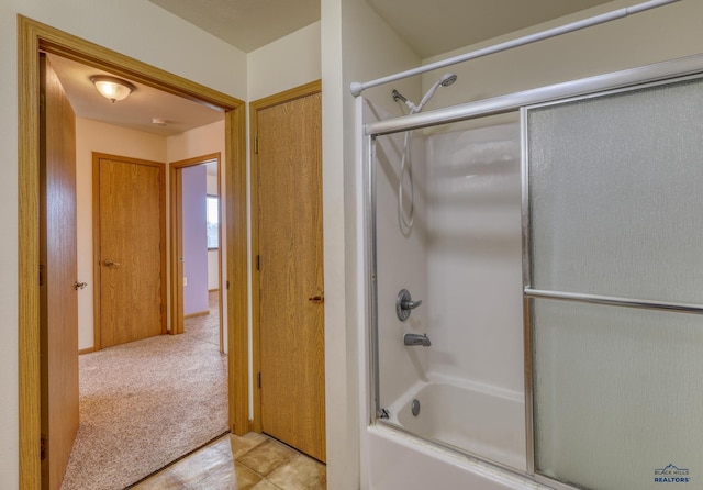 bathroom featuring tile patterned floors and enclosed tub / shower combo