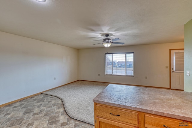 interior space featuring ceiling fan and a textured ceiling