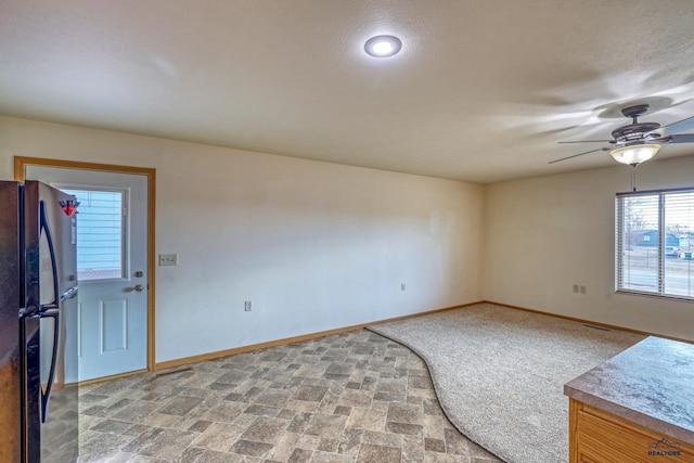 unfurnished room featuring ceiling fan and a textured ceiling