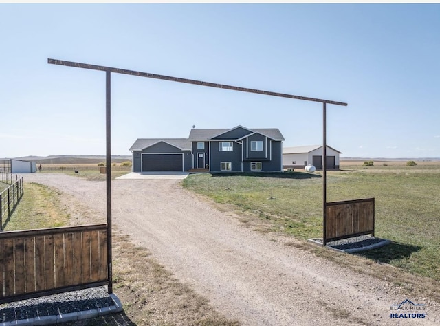 ranch-style home with a rural view and a garage