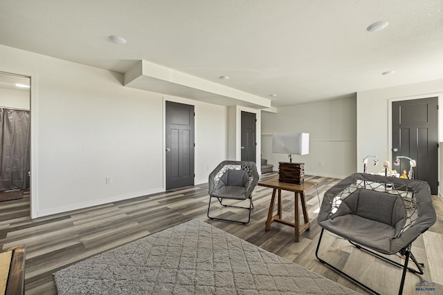 living room featuring dark hardwood / wood-style flooring and a textured ceiling