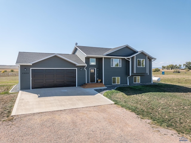 view of front of house with a garage and a front lawn