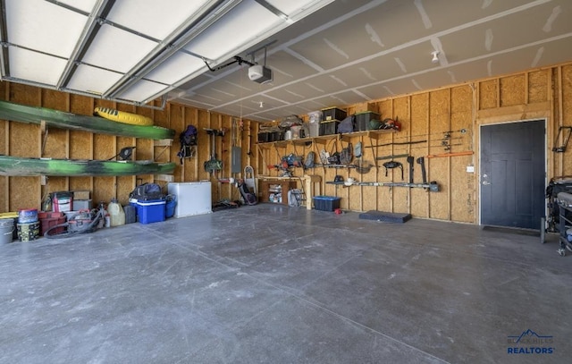 garage with electric panel and a garage door opener