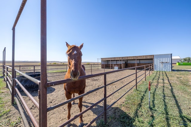 view of yard with an outbuilding and a rural view