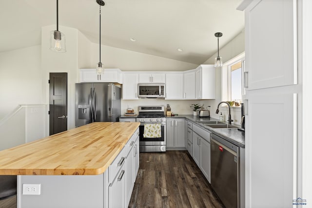 kitchen featuring white cabinets, sink, stainless steel appliances, and vaulted ceiling