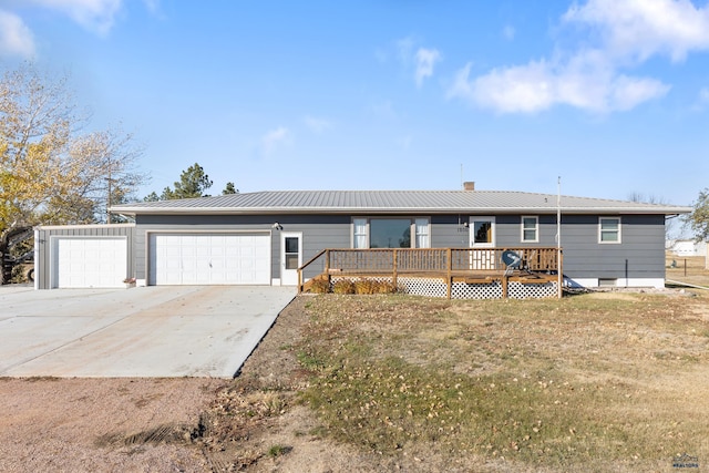 ranch-style house featuring a garage and a wooden deck