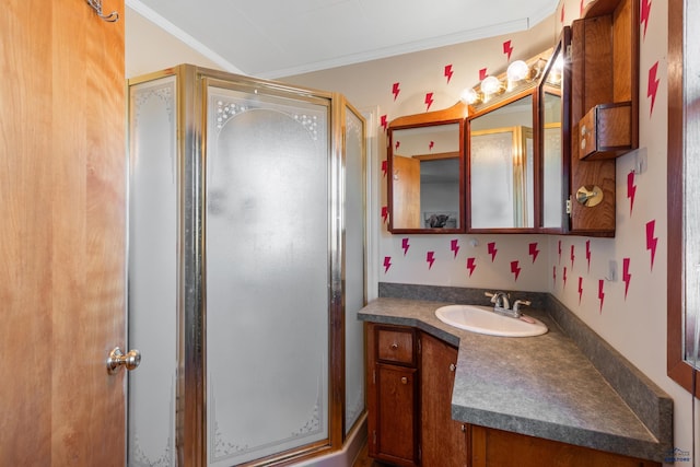 bathroom featuring vanity, an enclosed shower, and ornamental molding