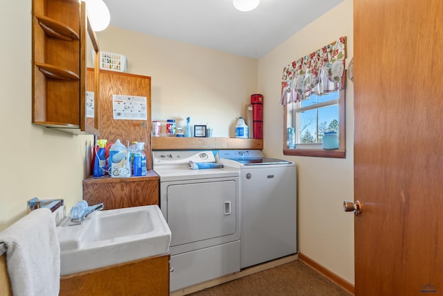 clothes washing area featuring carpet flooring, sink, and washing machine and clothes dryer