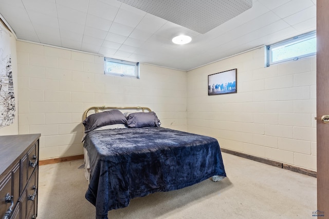 bedroom featuring light carpet and multiple windows