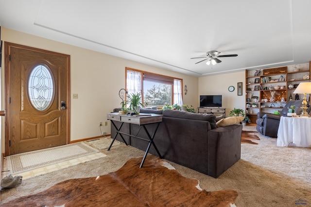 carpeted living room featuring ceiling fan