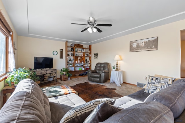 living room featuring hardwood / wood-style flooring and ceiling fan