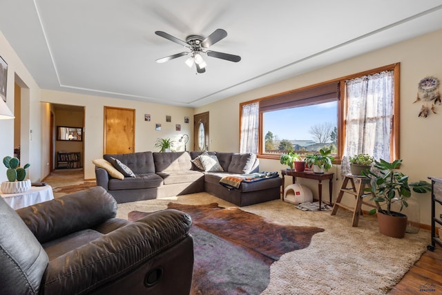 living room with wood-type flooring and ceiling fan