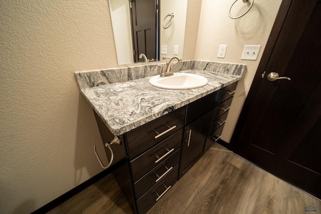 bathroom featuring hardwood / wood-style flooring and vanity