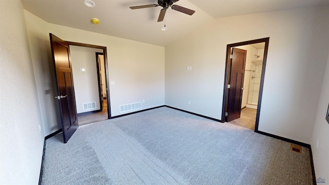 unfurnished bedroom with ensuite bathroom, lofted ceiling, light colored carpet, and ceiling fan