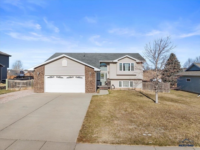 view of front of home with a front yard and a garage