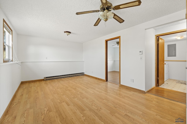 empty room with a textured ceiling, a baseboard radiator, light hardwood / wood-style flooring, and ceiling fan