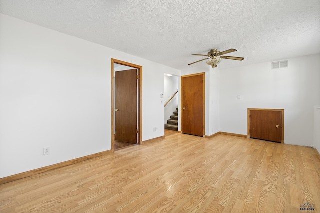 spare room featuring ceiling fan, a textured ceiling, and light hardwood / wood-style flooring