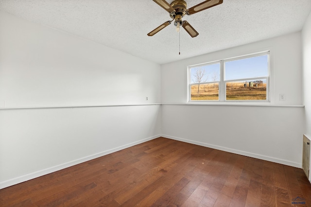 unfurnished room with ceiling fan, wood-type flooring, and a textured ceiling