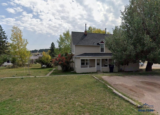 view of front facade with covered porch and a front lawn