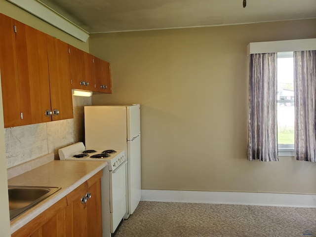 kitchen with white range oven, decorative backsplash, a wealth of natural light, and sink