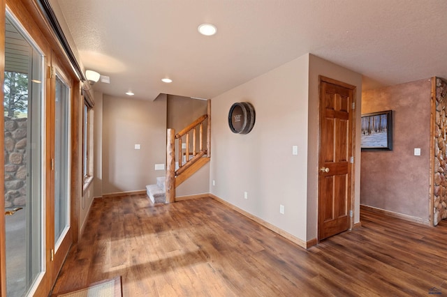 foyer with a textured ceiling and dark wood-type flooring