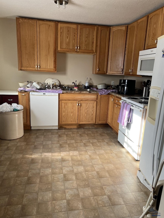 810 Blaine Ave, Rapid City, SD 57701 - kitchen featuring a textured ceiling, white appliances, and sink