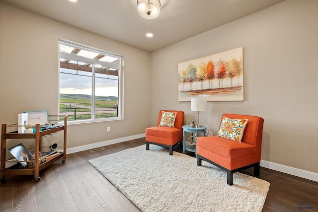 sitting room featuring dark hardwood / wood-style floors