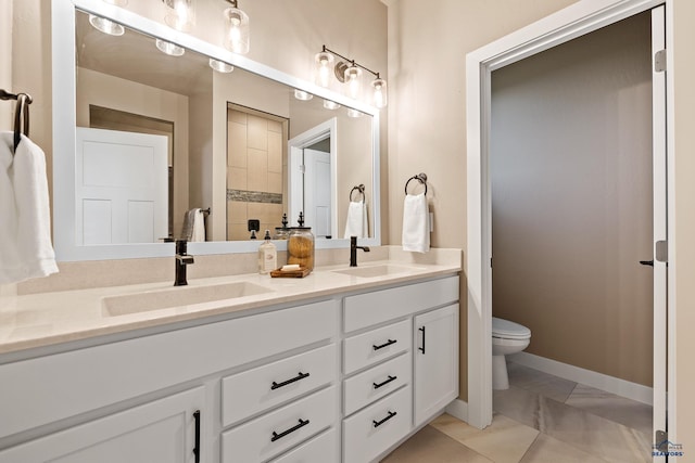 bathroom featuring tile patterned floors, vanity, and toilet