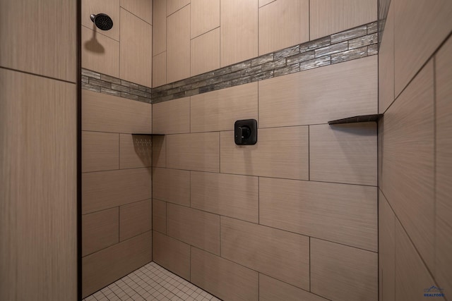 bathroom with tiled shower