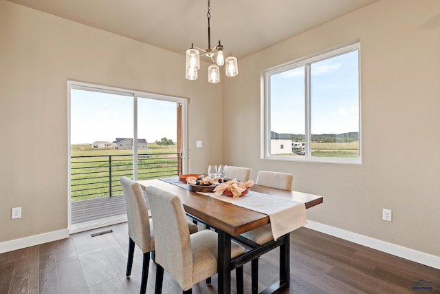 dining room featuring a notable chandelier and dark hardwood / wood-style floors