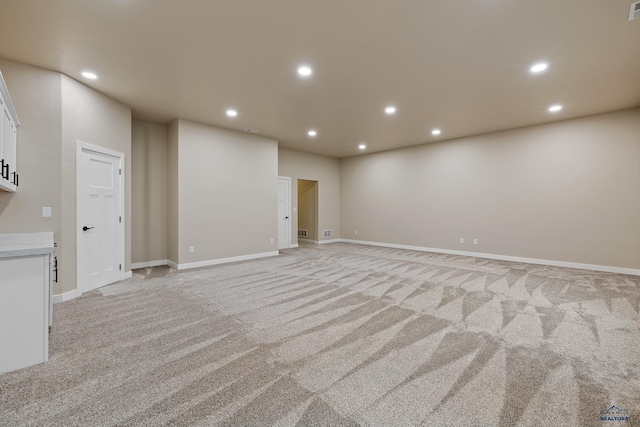 unfurnished living room featuring light carpet