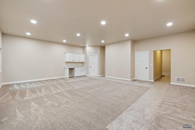 unfurnished living room with light carpet