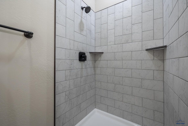 bathroom with tiled shower