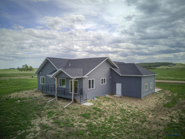 rear view of house with a yard