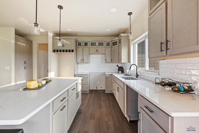 kitchen with dark hardwood / wood-style flooring, backsplash, sink, pendant lighting, and a center island