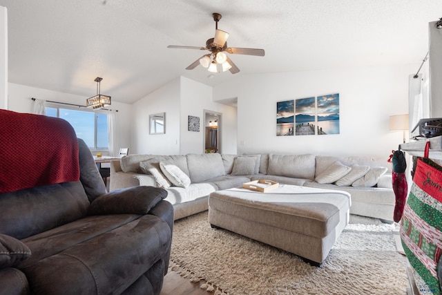 living room with light hardwood / wood-style floors, vaulted ceiling, and ceiling fan