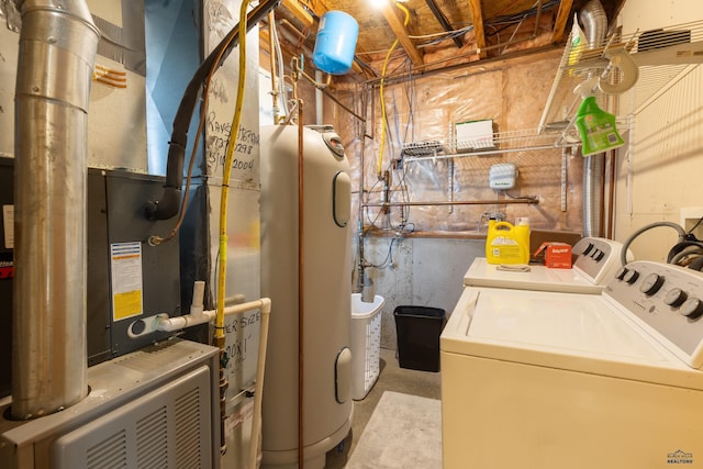 clothes washing area with washing machine and dryer and electric water heater