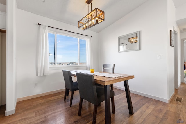 dining space with hardwood / wood-style flooring and lofted ceiling