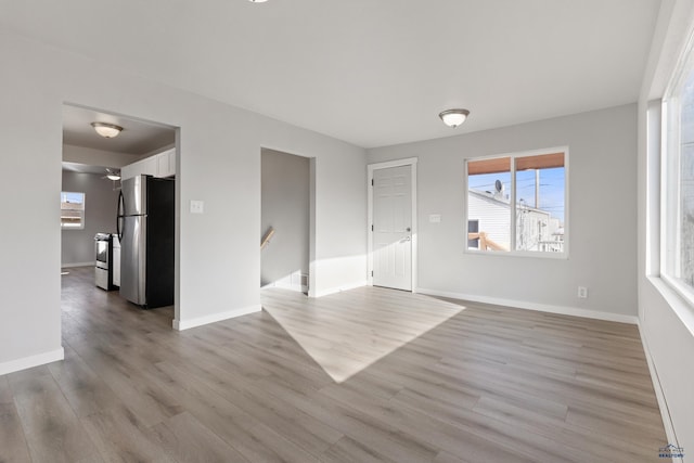 unfurnished room with light wood-type flooring