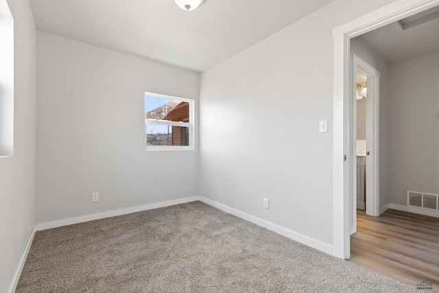 spare room featuring light carpet