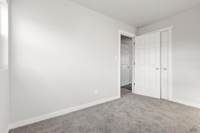 unfurnished bedroom with carpet and a closet