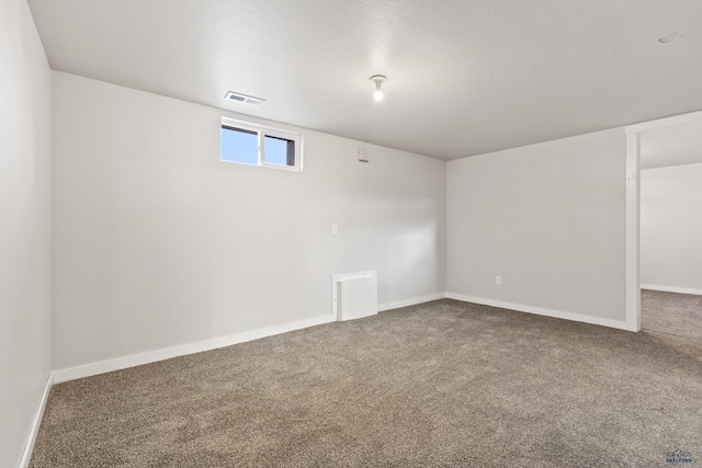 basement with carpet flooring and a textured ceiling