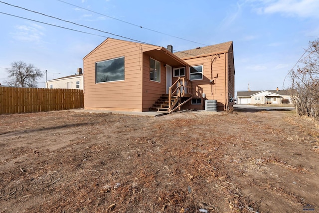 rear view of house featuring central air condition unit