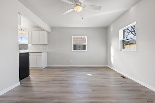 interior space featuring beamed ceiling, light wood-type flooring, and ceiling fan