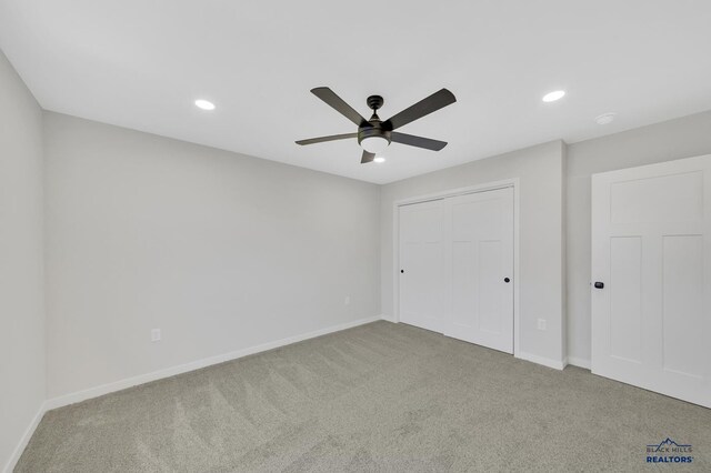 unfurnished bedroom with carpet, a closet, and ceiling fan