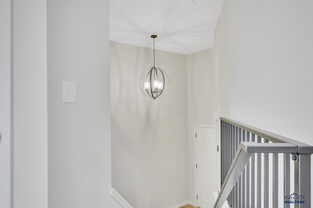 stairway with an inviting chandelier