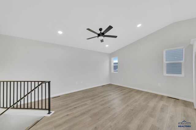 unfurnished room featuring ceiling fan, light hardwood / wood-style floors, and lofted ceiling